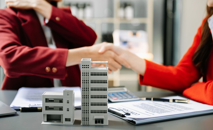 Signing a contract. Client and broker agent, lease agreement, successful deal and  Young business sitting at the desk in modern office